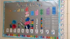 a bulletin board with numbers and objects on it in a classroom setting for children to learn