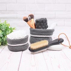 two crocheted baskets with brushes and combs in them