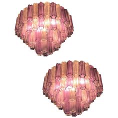 two pink glass lights hanging from the ceiling