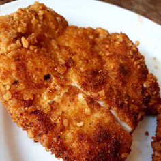 two pieces of fried chicken on a white plate