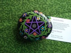 a decorated rock sitting on top of a green table