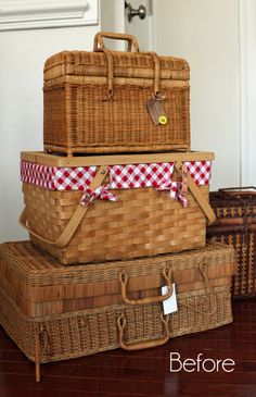 three wicker suitcases stacked on top of each other in front of a door