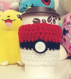 a coffee cup with a pokemon mug cozy on it