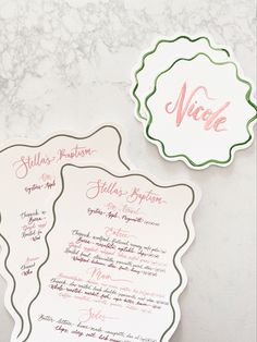 two wedding stationery cards on a table