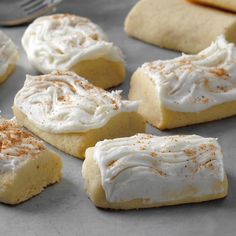 several pieces of cake with white frosting and cinnamon sprinkles