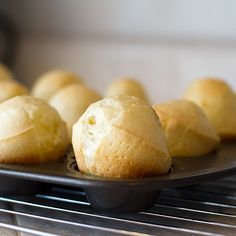 several rolls are on a plate in the oven