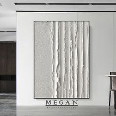 a chair and table in front of a white wall with the word megan on it