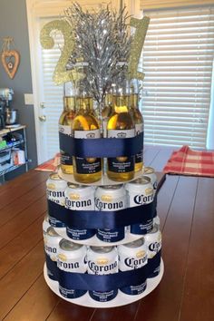 a cake made out of beer bottles on top of a wooden table