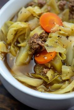 a white bowl filled with meat and vegetable soup