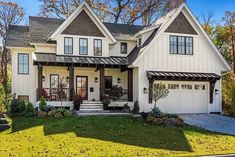 a large white house with two storys and lots of windows on the front porch