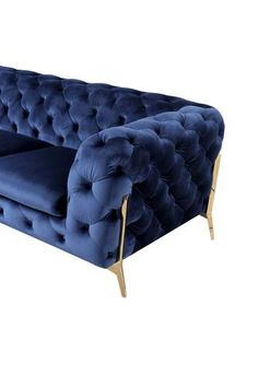 a blue velvet couch with gold legs