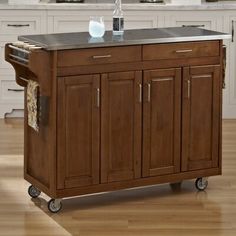 a kitchen island cart with stainless steel top