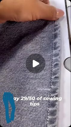 someone is sewsing their jeans with scissors