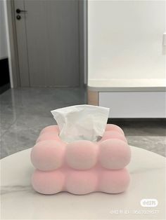 a tissue dispenser sitting on top of a table