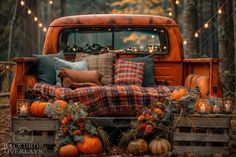 an orange truck with plaid pillows and pumpkins on the bed