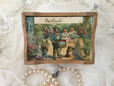 an old fashioned greeting card with pearls and beads