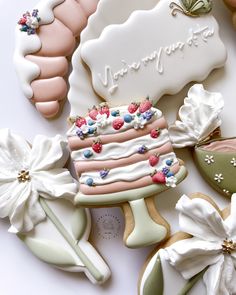 decorated cookies are displayed on a white surface