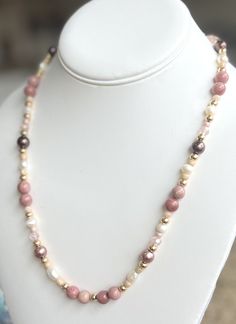 Thank you for visiting my shop, Vintage Charms Studio. All items are handmade by me in my studio in southern California with the utmost attention to detail, quality and sustainability. This handmade healing Rhodochronite necklace is made with real freshwater pearls, semi precious pink Rhodochrosite crystals, Czech glass beads, 18k gold accents, and an 18k gold plated toggle clasp.  This piece is 20 inches and beautifully made, a perfect gift Mother's Day, birthdays, showers, Anniversary gifts, best friend gifts and anytime wear. Each piece comes in an elegant drawstring gift bag as shown and includes a small free gift! Please contact me with any questions.  Shipping Every item is carefully wrapped for shipment and includes a small keepsake adjustable woven pouch. Extra Gift wrapping is ava Rhodonite Crystal, Gifts Best Friend, Pink Rhodonite, Pink Rhodochrosite, Friend Gifts, Crystal Stone, Toggle Clasp, Czech Glass Beads, Gold Beads