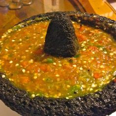 a bowl filled with soup sitting on top of a table