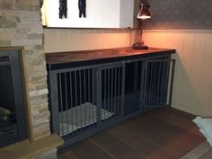 a dog kennel in the corner of a room with a fireplace and light on