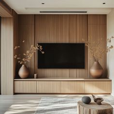 a living room filled with furniture and a flat screen tv on top of a wooden wall