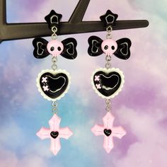 "Pastel goth earrings- fun cute cartoon earrings - skull bow cross heart - statement earrings - Japanese street fashion earrings Fun kawaii earrings perfect for the pastel goth lover! Stay stylish in these black and pink goth style earrings. 12mm wide plastic and silicone rubber backings included for comfort **Stainless steel earring posts are hypoallergenic and nickel free Made of resin / plastic Charms are one sided and flat on the back Earring length is: 3 5/8\" (in) Earring width is: 1\" (in Pink Goth Jewelry, Cute Goth Earrings, Kawaii Goth Accessories, Punk Heart-shaped Earrings For Gifts, Punk Heart Earrings As A Gift, Punk Style Heart Shaped Earrings For Gift, Punk Style Heart Earrings For Gift, Punk Heart-shaped Earrings, Punk Style Heart-shaped Earrings As Gift