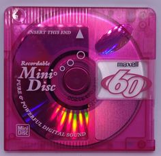 the cd is pink and has an image of a computer mouse on top of it