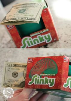 two boxes with money in them sitting on a counter top, one is empty and the other has an unopened dollar bill sticking out of it