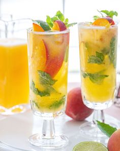 two glasses filled with fruit on top of a table