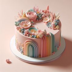 there is a cake decorated with rainbows and flowers