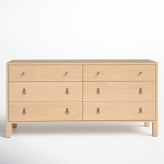 a wooden dresser with six drawers and two pulls on each drawer, against a white background