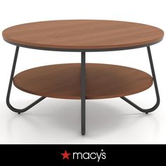 a round wooden table with metal legs and a star on the bottom that says macy's