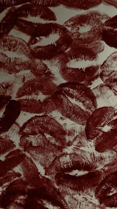 a bunch of brown feathers sitting on top of a white table covered in black ink