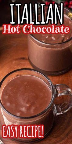 two glasses filled with chocolate pudding sitting on top of a wooden table next to each other