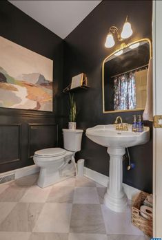 a bathroom with black walls, white fixtures and a checkered flooring pattern on the floor