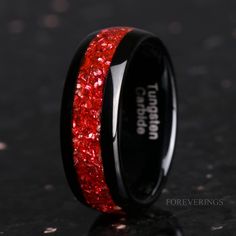 a black ring with red glitter inlays on the inside and outside of it