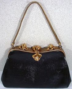 "We are pleased to off exclusively to our Etsy shoppers the wonderful Vintage Lizard Skin purse dating from the 1050's. The frame for the purse is in a gold tone finish with a hand tooled finish. There are three Iris Flowers on the top of the frame and a single Iris for the clasp All are accented with Sparkling Rhinestones and a mesh handle that also extends from the frame. Some wear to the finish of the gold coloring on the back part of the frame but, you really have to look hard to find it. Th Vintage Formal Bags With Gold Clasp, Vintage Bags With Gold-tone Hardware, Compact Evening Bags With Gold-tone Hardware, Mid-century Gold Evening Bag, Formal Compact Bag With Gold-tone Hardware, Compact Formal Bags With Gold-tone Hardware, Compact Formal Bag With Gold-tone Hardware, Gold Rectangular Bag For Luncheon, Vintage Evening Bag With Gold-tone Hardware