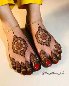 the feet are decorated with henna designs