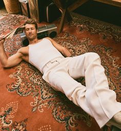 a man laying on the floor with his legs crossed