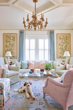 a living room filled with lots of furniture and a chandelier hanging from the ceiling