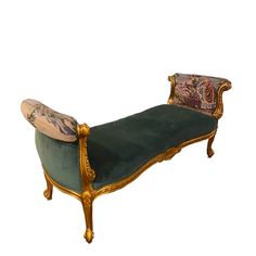 an antique chaise lounge with green velvet upholstered and gold trimmings