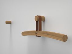 two wooden hooks are attached to the wall