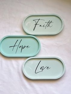 three oval trays with writing on them that say faith, hope, and love