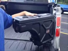 a man is holding the back end of his truck