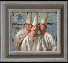 two men with white hats on their heads are looking at another man's face