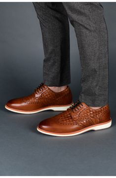 Woven insets and a bright white sole make the look both relaxed and sporty in a wingtip derby punctuated with classic broguing. Lace-up style Memory foam footbed Leather upper and lining/synthetic sole Imported Men's Shoes Leather Wingtip Lace-up Shoes For Business Casual, Brown Wingtip Leather Shoes With Perforated Toe Box, Brown Wingtip Oxfords With Textured Sole, Brown Oxfords With Perforated Toe For Business Casual, Brown Wingtip Leather Shoes With Cushioned Footbed, Casual Brown Wingtip Dress Shoes, Casual Brown Dress Shoes With Perforated Toe Box, Brown Wingtip Lace-up Shoes With Textured Sole, Brown Oxfords With Perforated Toe Box