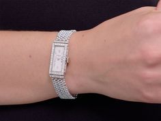 The elongated rectangular ivory dial with Roman numerals, marked "J. Jarre", within a French-cut diamond set bezel, to seven row gray and white seed pearl bracelet, with French-cut diamond spacer accents, the case engraved with Greek key and floral motifs. Movement signed M & W Ullmann. Pearl Watch, Jewellery Marketing, French Cut, Pearl Design, Art Deco Diamond, Seed Pearl, Greek Key, Diamond Set, Roman Numerals