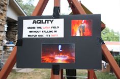 there is a sign with pictures on it that says agility cross the lava field without falling in watch out, it's hot