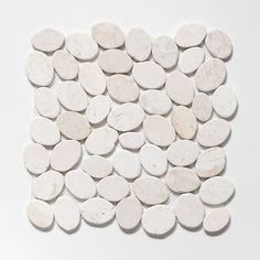 white pebbles arranged in a square shape on a white surface