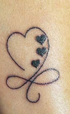 a small tattoo on the back of a woman's arm with hearts and leaves